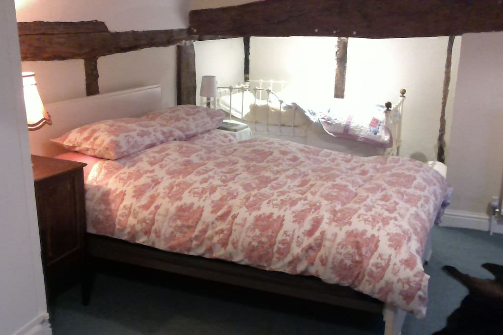 Probably the oldest room in the house, this quaint but spacious room, with en suite bathroom will sleep up to 4 with the antique cot bed under the beam and a travel cot available on request.