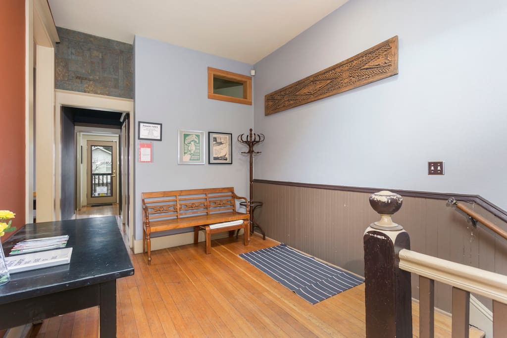 Foyer with coat rack + seating for putting on/removing shoes.