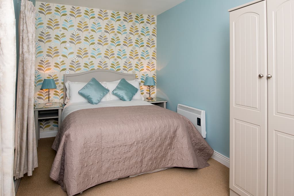 Luxury bed with quallity bed linen, wardrobe, chest of drawers, vanity area with mirror and hairdryer.