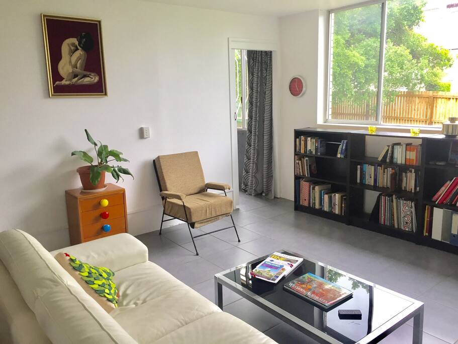 Large lounge to relax on, TV, ceiling fan, & books