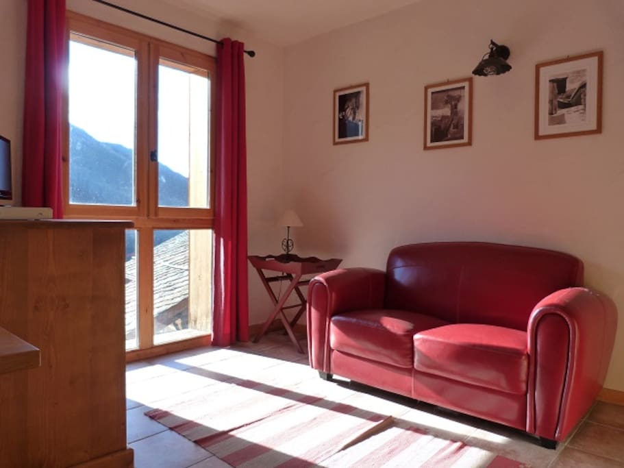 The lounge area has stunning views, red leather sofa and TV/DVD