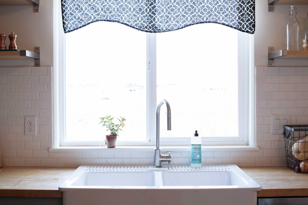 sink window looks onto a field of pumpkins or corn depending on the year