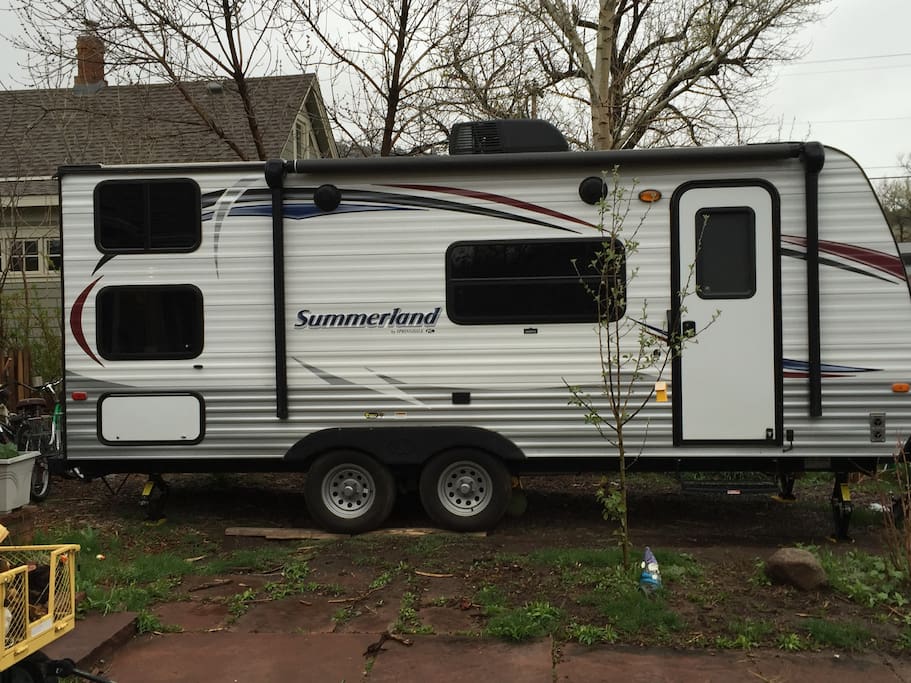 Entrance of camper, awning for shade.