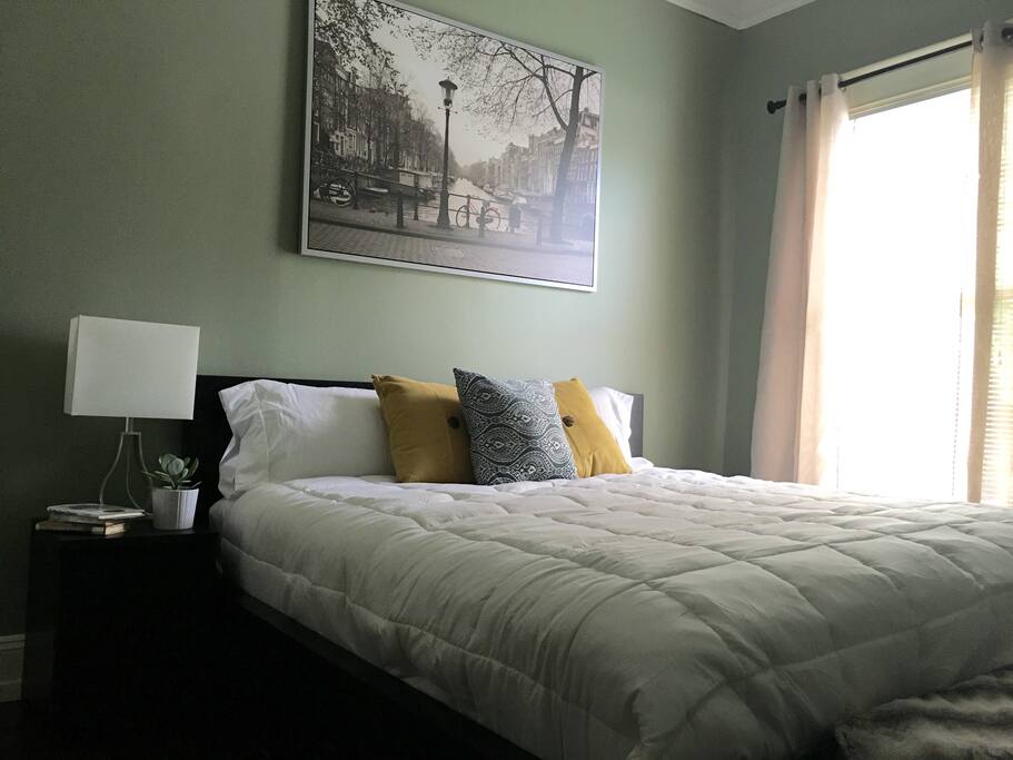 King size bed with natural light, and a desk.