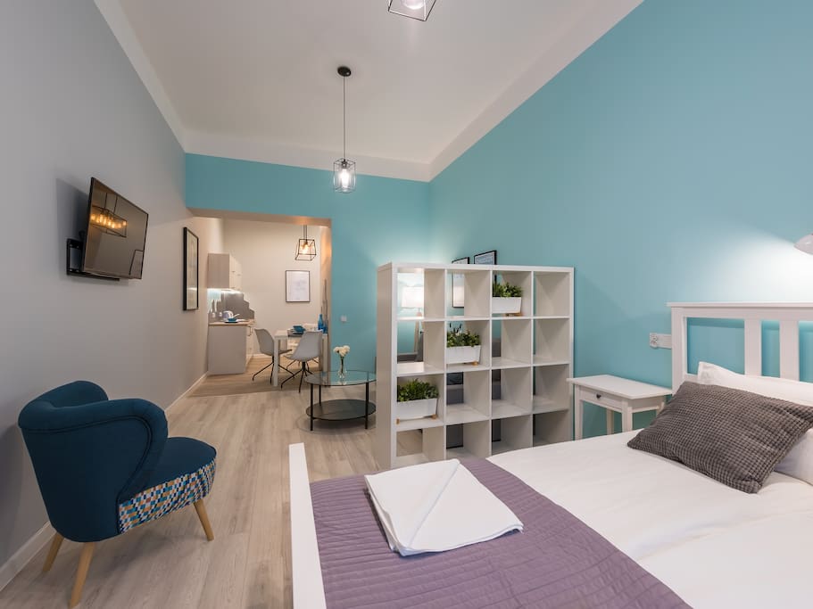 bedroom with kitchenette and armchair