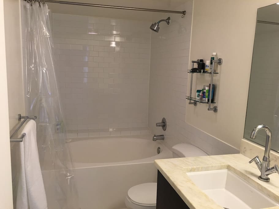 Shared bathroom and tub in unit.