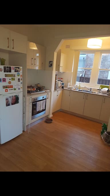 Kitchen with fridge, gas stove & oven & all usual utensils