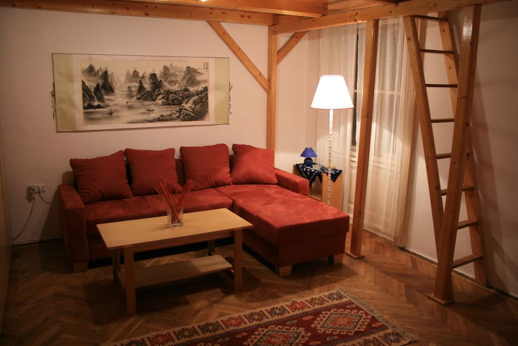 Comfy corner sofa-bed, can sleep two people. Above it, my favourite Chinese landscape, hand-painted Yangshuo. :)