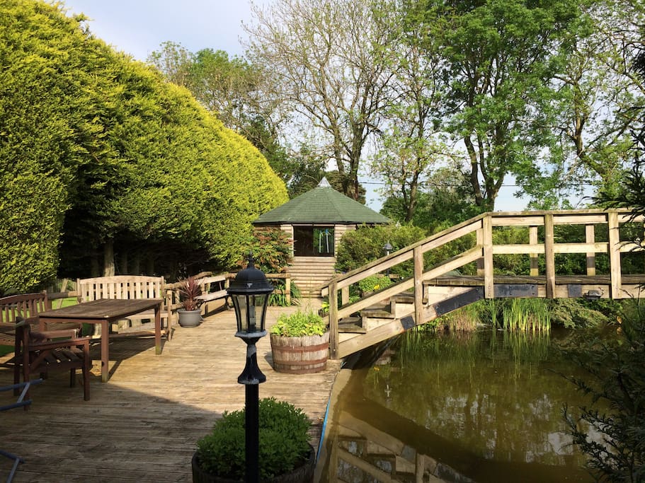 The shared garden with decking, seating, ponds etc. The quiet summerhouse in the back ground is ideal for reading.