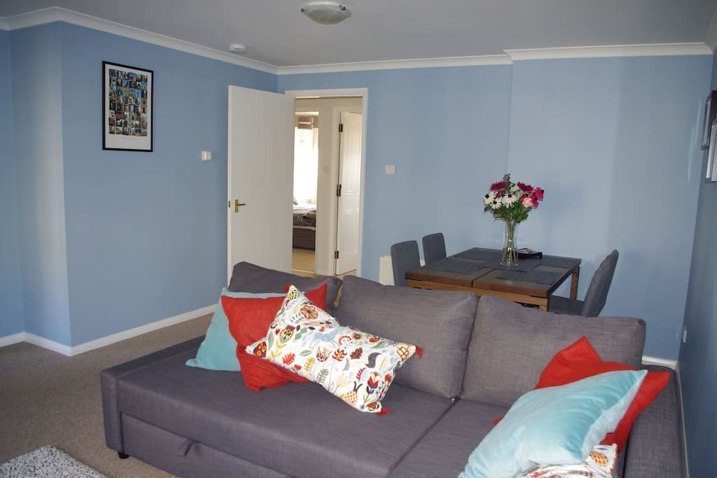 Sofa bed with dining area behind