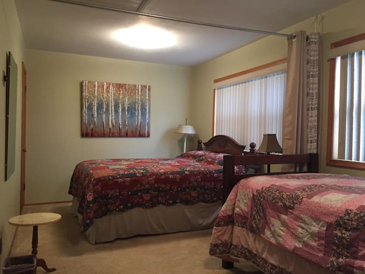 Large bedroom one queen and one single bed with privacy curtain