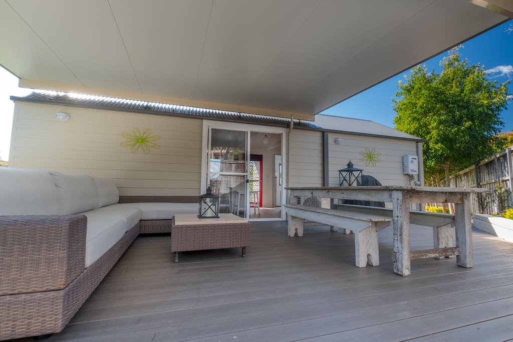 Covered outdoor lounge and dining area with BBQ