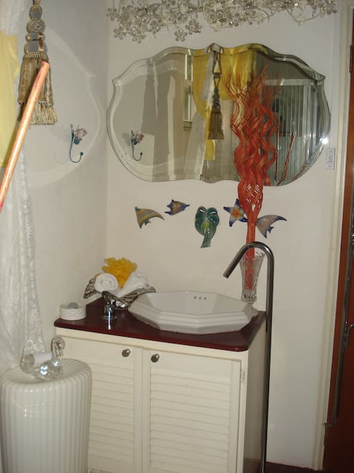 Beautiful chandelier over mirror lighting individual sink