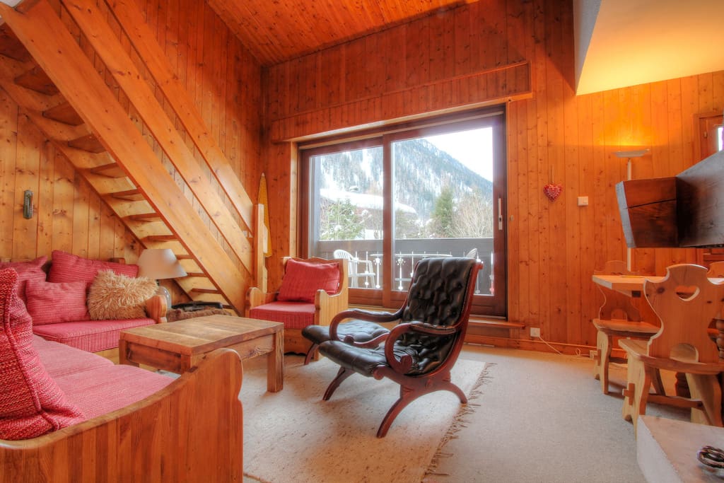 A large French window with access to the balcony offers stunning mountain views.