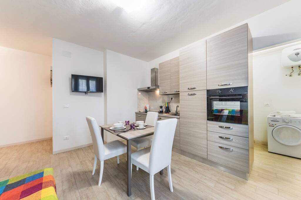 Living room with dining table and sofa and flat screen TV