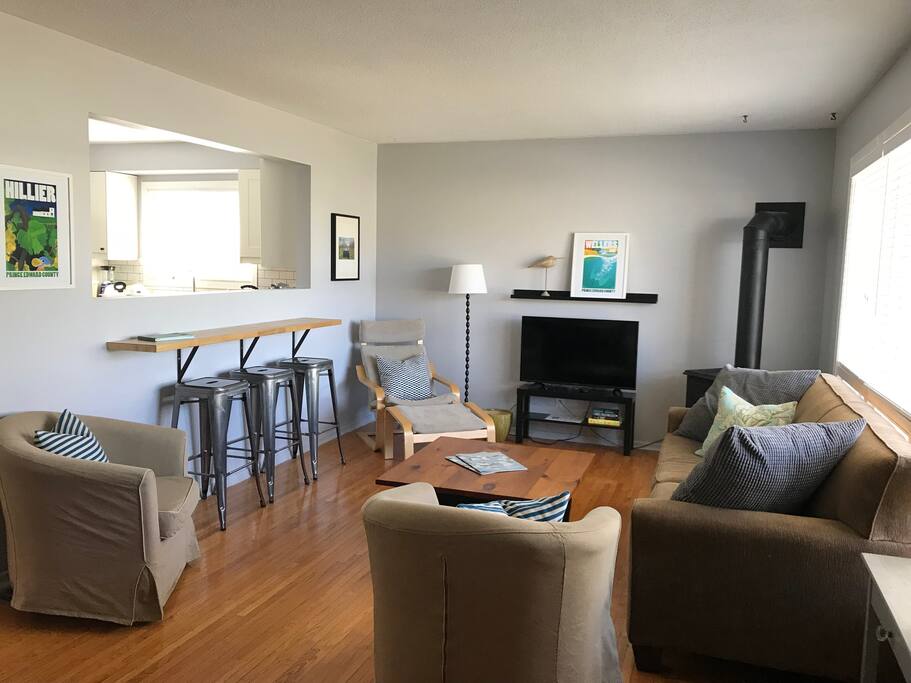 Main floor living room open to kitchen and front entry.