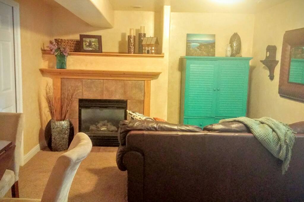 Front room with tv and fireplace. May occasionally hear tv from adjacent occupants through the wall.