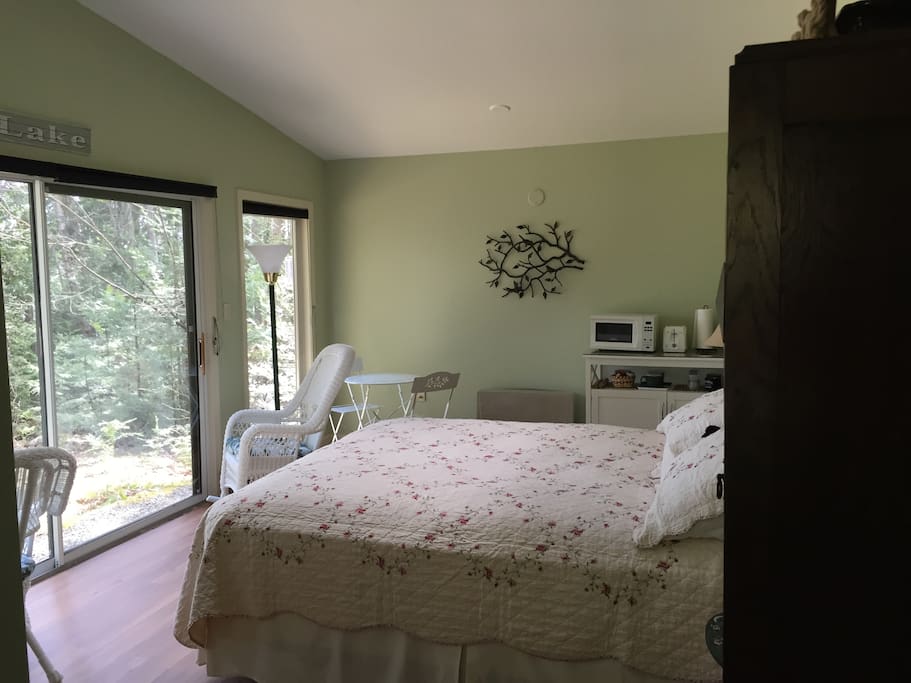 Comfortable queen sized bed looking out on the lake