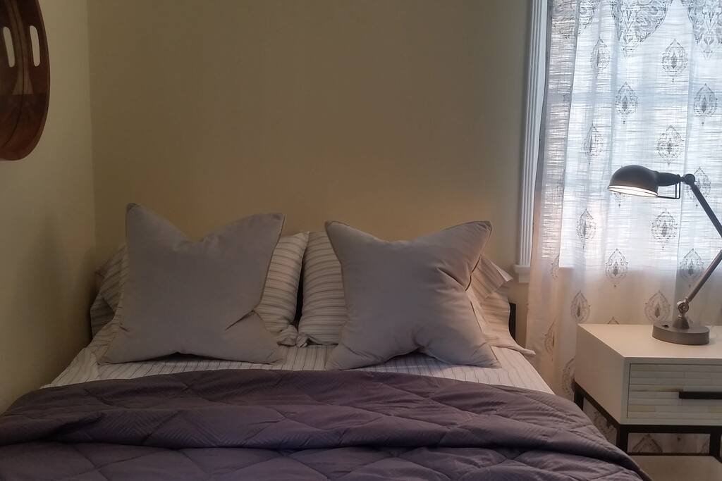 Private bedroom includes a full-size bed, bedding, and closet.