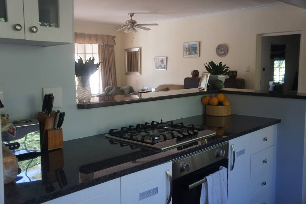 Newly renovated open-plan kitchen overlooking the lounge, pool and patio