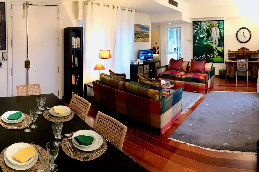 a panoramic view of the large living room with dining area