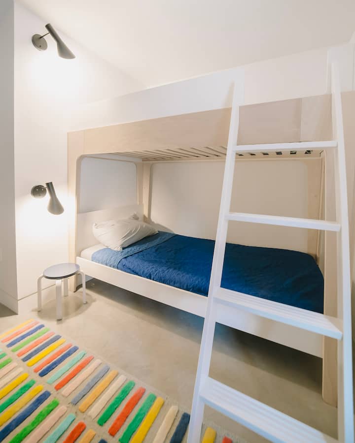 The bunk room measures 7'-0" x 10'-6".  The bunks include (2) single mattresses, and these are best suited for kids.