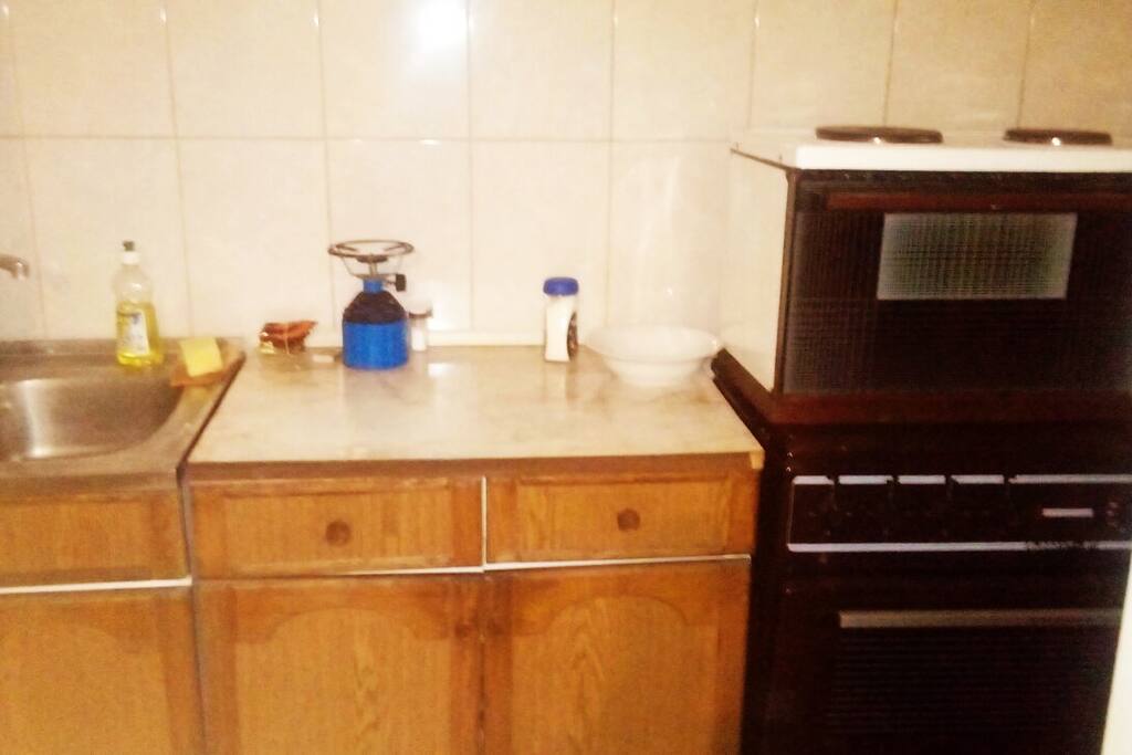Kitchen fully equipped with fridge, stove and other standard white goods.