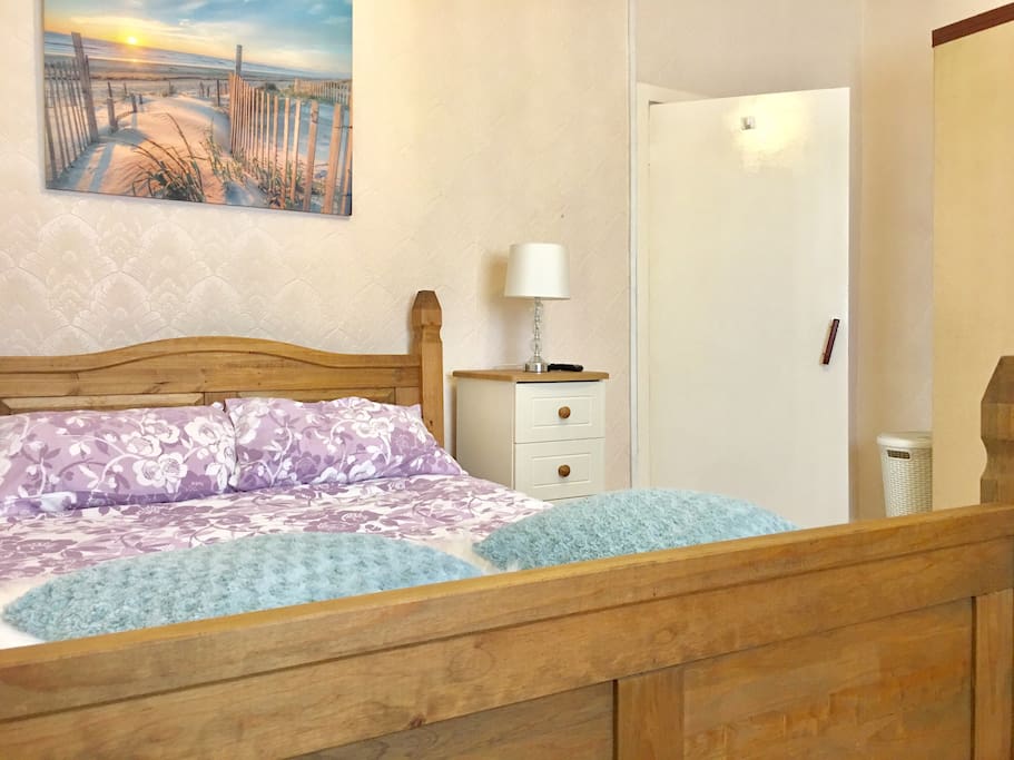 Spacious Bedroom With Comfortable Bed.