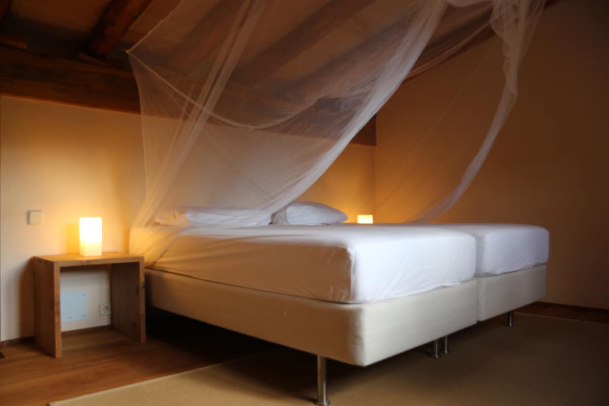 Two single beds on the separate upper level of an ocean view apartment can also be moved separately if necessary