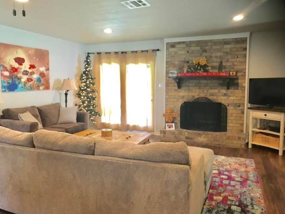 Open concept living room with wood burning fireplace