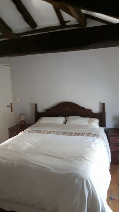 Double bedroom complete with beautiful vaulted beams, side cabinets, dressing table chair.