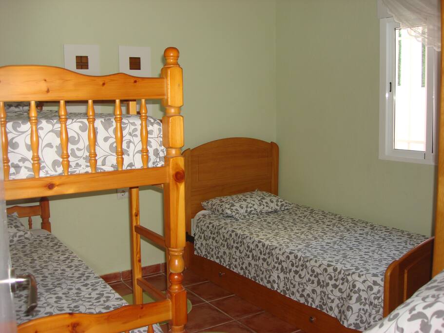 The third bedroom which has a single bed with a pullout bed under and one set of bunk beds