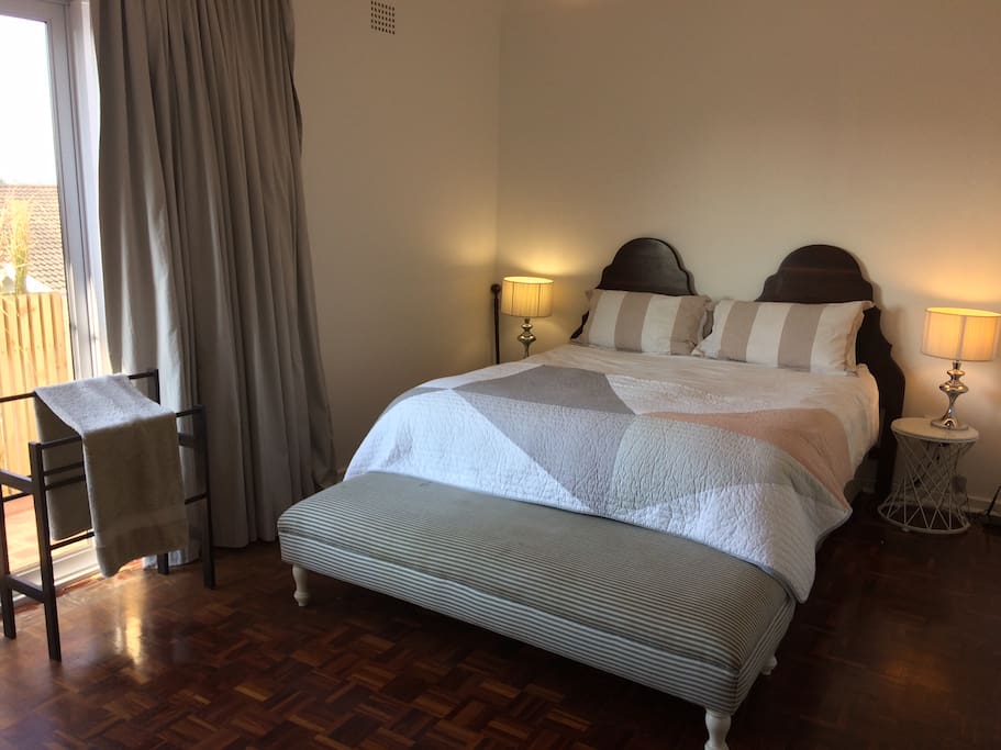 Queen size bed in the main room, including a balcony overlooking the city lights.