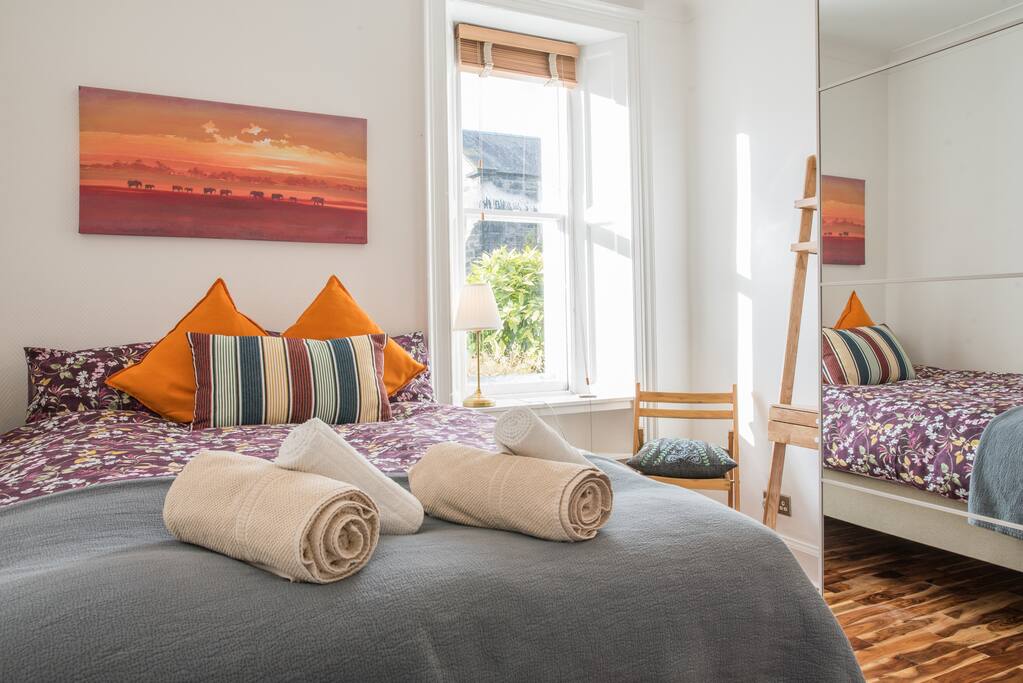 Bright and sunny bedroom 1 has a double bed and dressing table