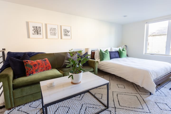 A view of the loft. The bed is a comfy memory foam queen. The green sofa is a pullout couch. 