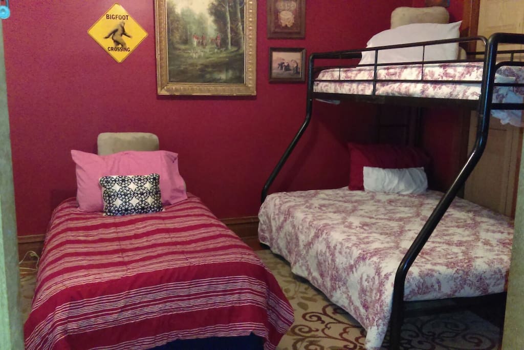 The twin size bed portion of a shared room that will host up to 4 people.