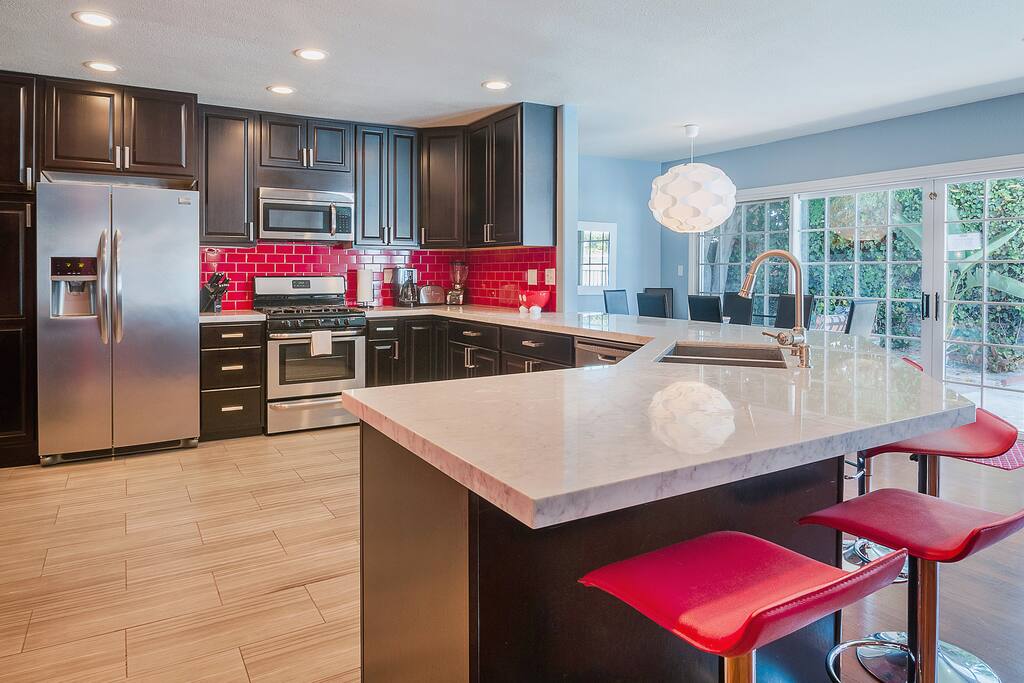 Brand new gourmet kitchen with a 6 seater bar and an 8 seater dining table
