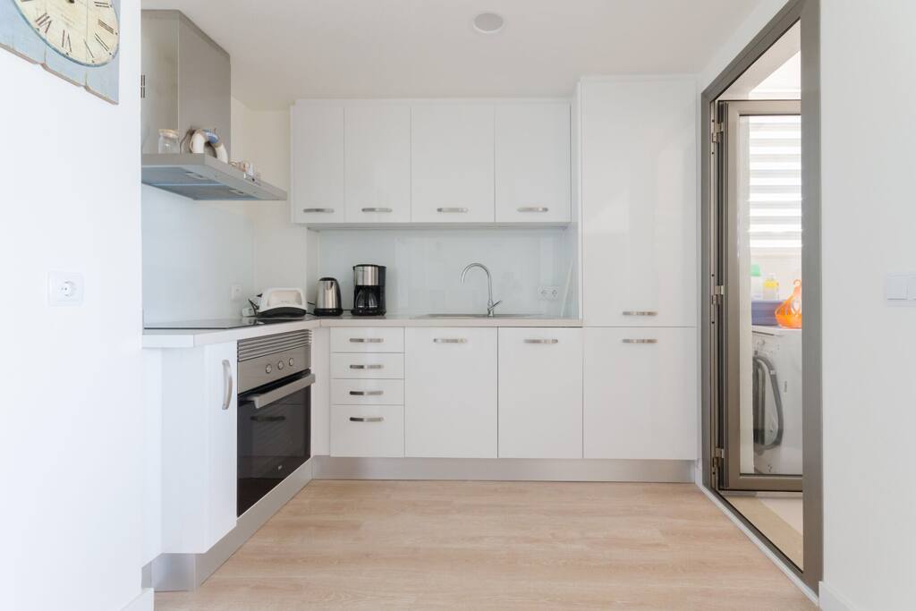 Kitchen with utility room on the right side ( washing-machine etc.)