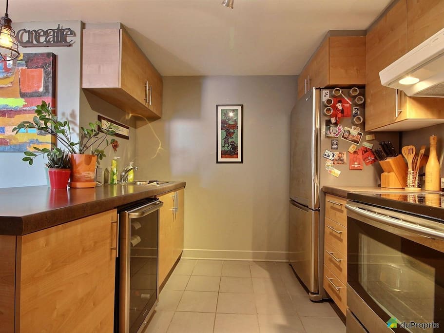A spacious and modern kitchen with large countertops and modern appliances for your needs.