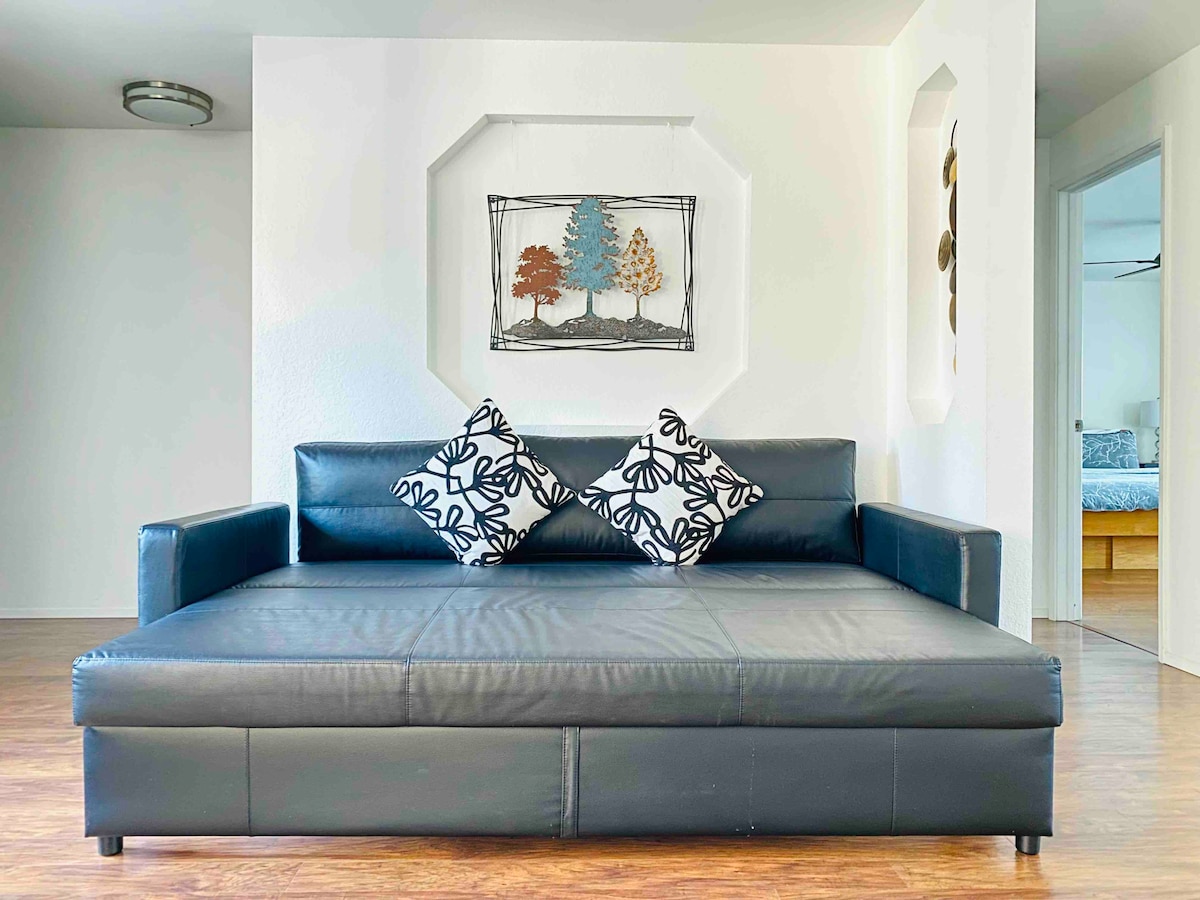 El sofá cama en la sala de estar puede convertirse en una cama tamaño queen para 2 personas.