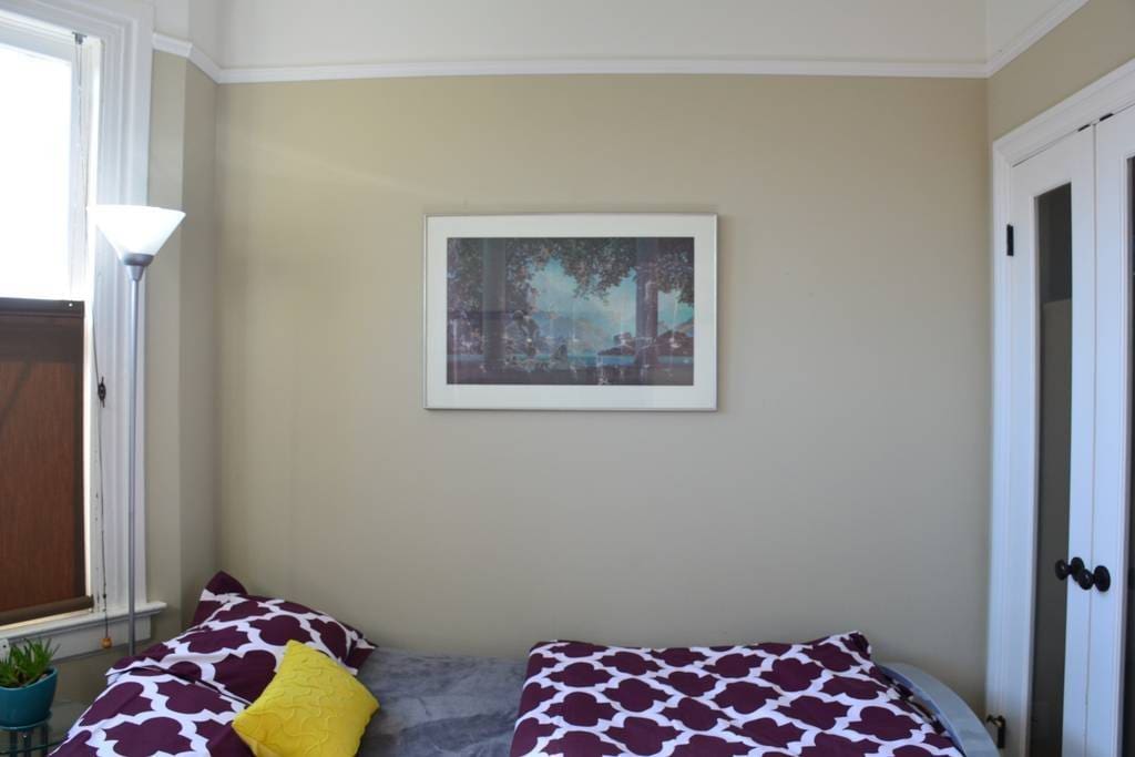 Your bedroom right next to front entrance. Beautiful morning sunlight through bay windows. Full-sized futon: super comfortable with plush memory foam topper.
