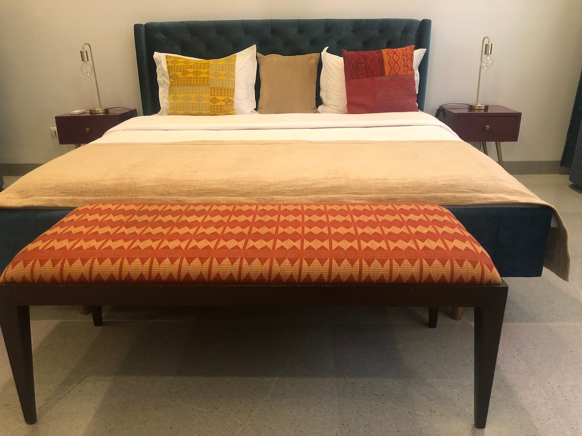 The bedroom with a cabinet and bedsides. The bedroom has a wardrobe and bedside tables.