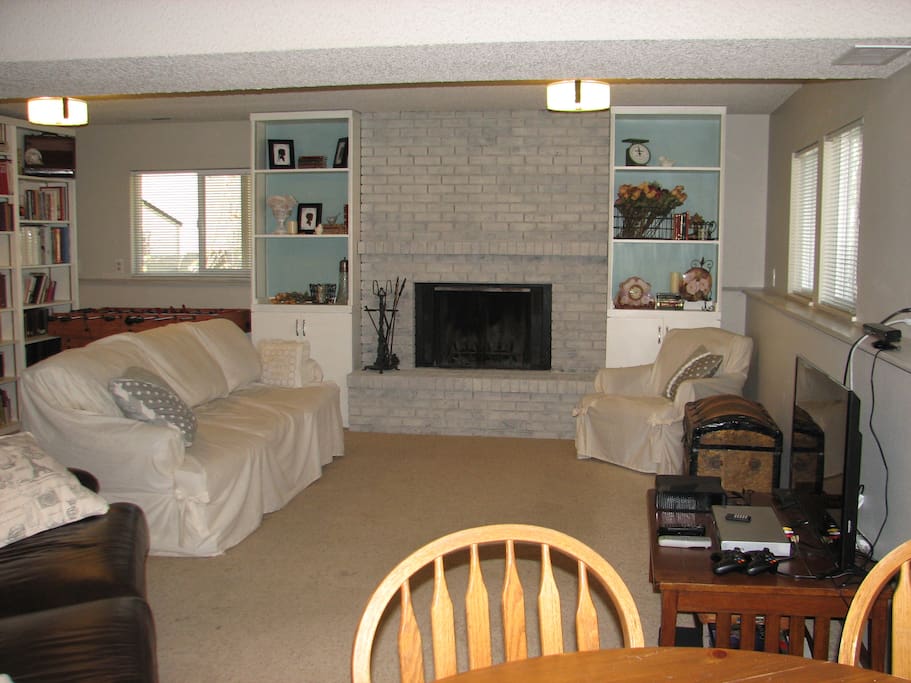Downstairs living area, with TV, fooseball and piano