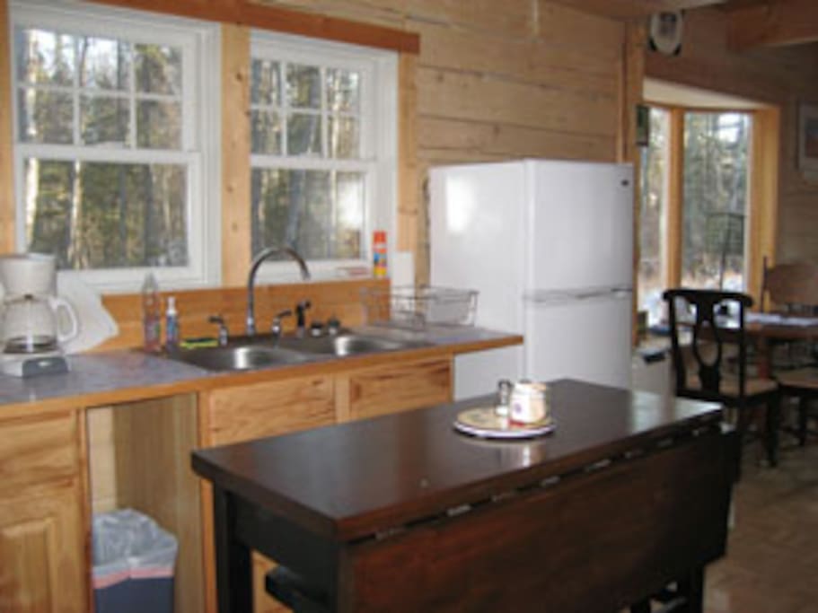The functional kitchen also has a four burner propane range with oven.