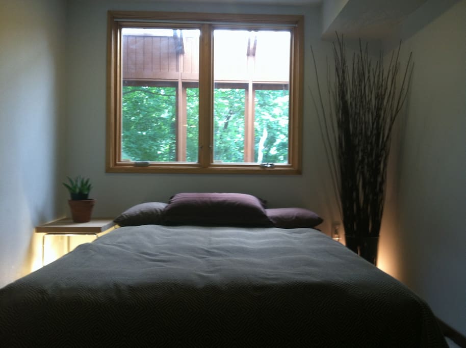 Bedroom with view of the woods