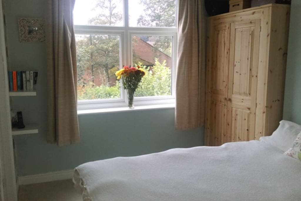double bedroom with cupboard and large window