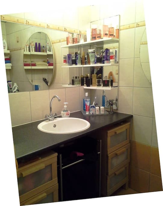 Bathroom with a shower, washer, dryer, ironing board and iron