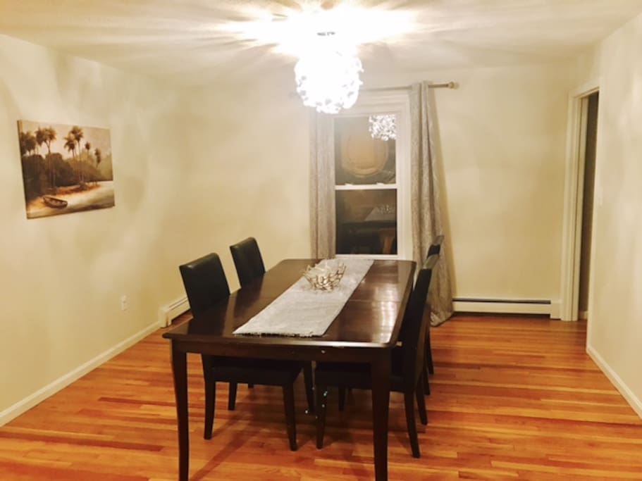 Dining table with four leather chairs.