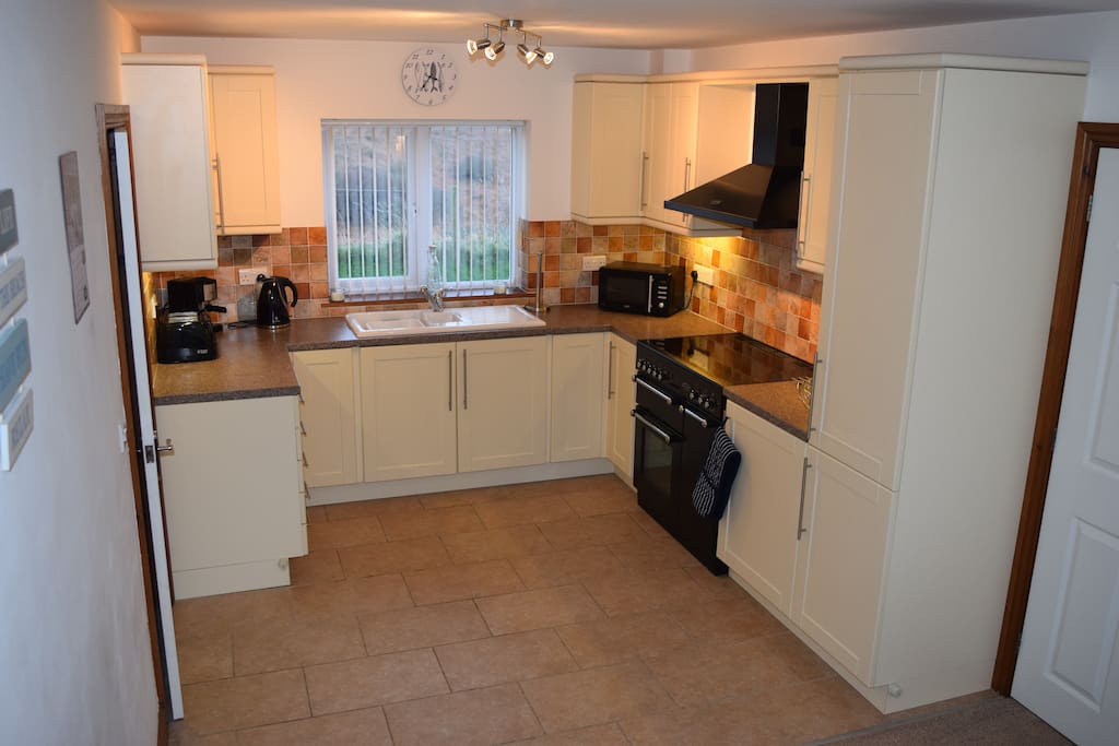 Well equipped kitchen with separate utility room