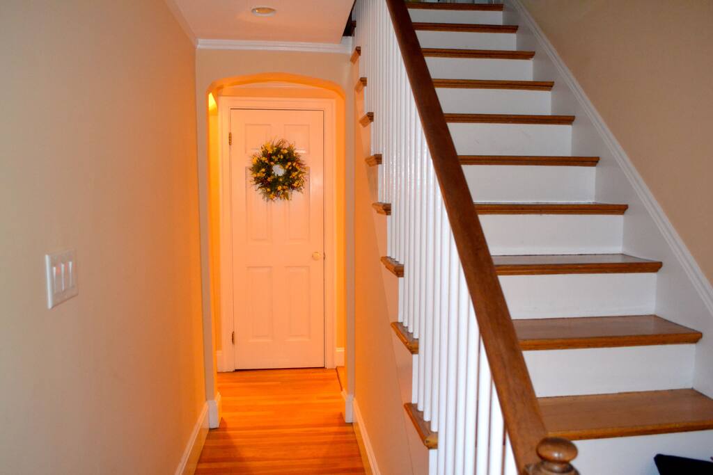 Front hallway, stairs lead up to three bedrooms on second floor